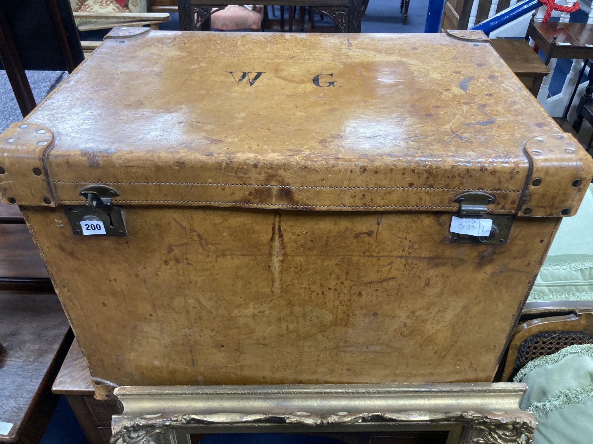 A large Victorian tan leather travelling trunk, width 76cm, depth 52cm, height 58cm together with a rectangular gilt gesso picture fram